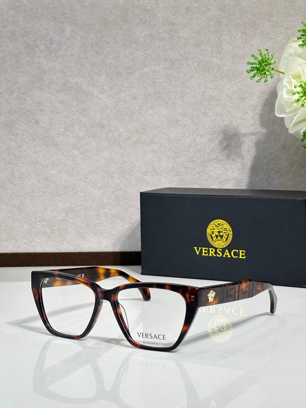Tortoise rectangular eyeglasses with clear lenses and VERSACE logo on temple arms