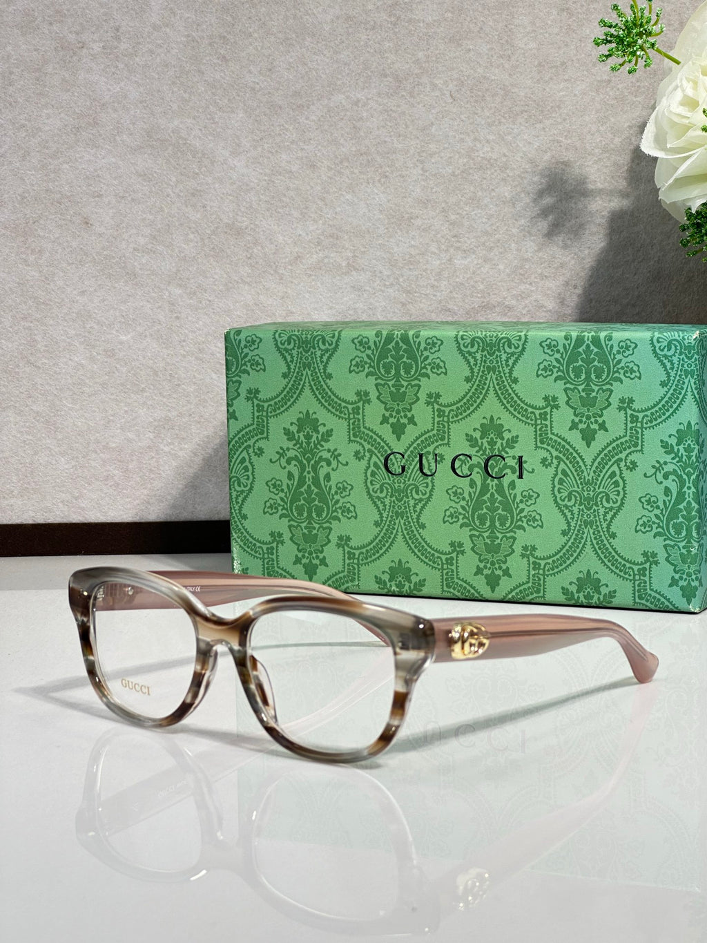 Gucci eyeglasses with tortoiseshell frames and gold logo hinge detail