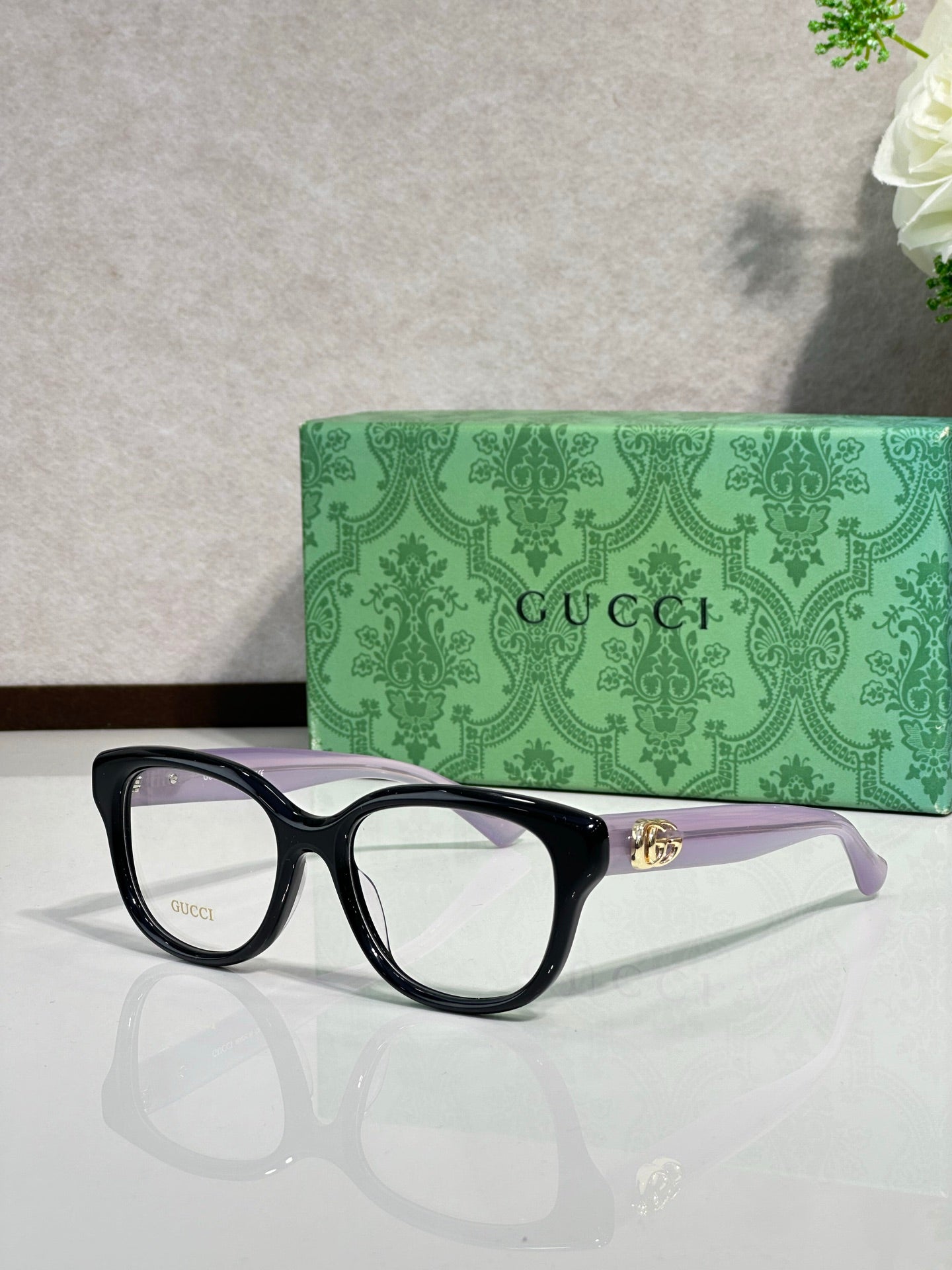 Gucci eyeglasses with black frames and gold logo temple detail