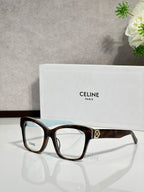 Tortoiseshell eyeglass frames with clear lenses and gold-tone logo at temple