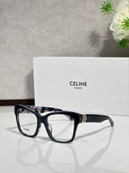 Dark blue-black eyeglass frames with clear lenses and gold-tone logo at temple