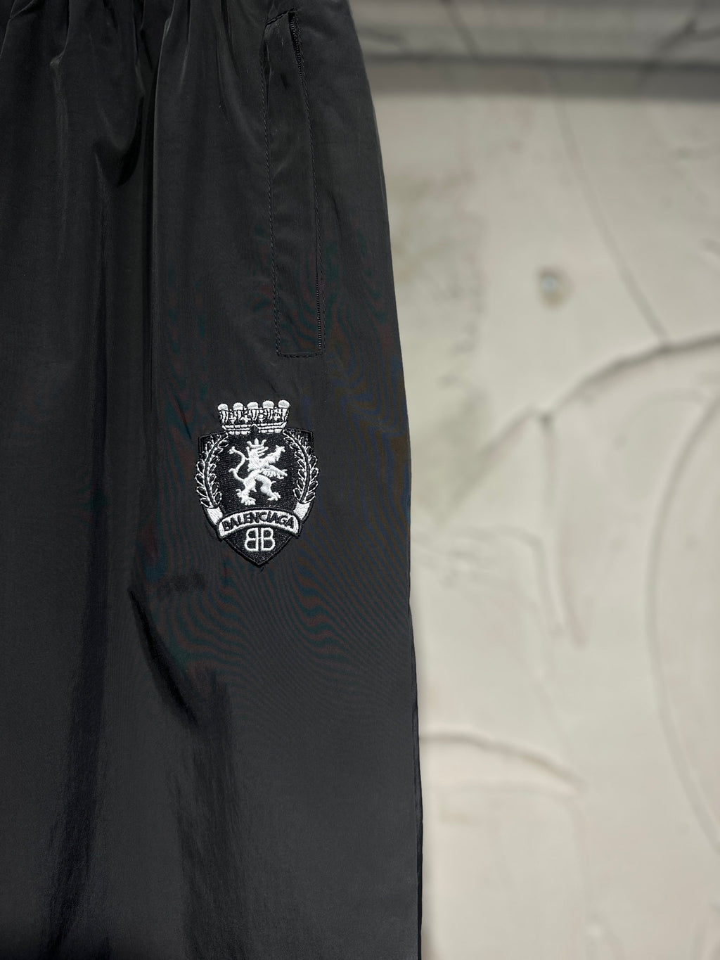 Black pants showing crest-style side logo embroidery