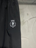 Black pants showing crest-style side logo embroidery