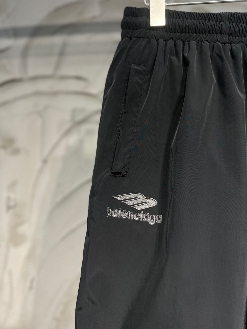 Black pants with side panel seams and “balenciaga” logo embroidery