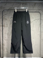 Black Balenciaga wide-leg pants with elastic waistband and embroidered side logos