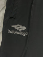 Black pants with “balenciaga” logo and sail-like graphic embroidery