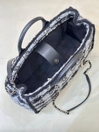 Chanel tote bag open view showing navy fabric lining and chain shoulder strap