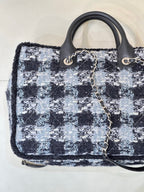 Chanel tote bag front angle showing blue/black tweed texture and gold logo detail