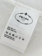White fabric care label with Prada Milano and laundry symbols