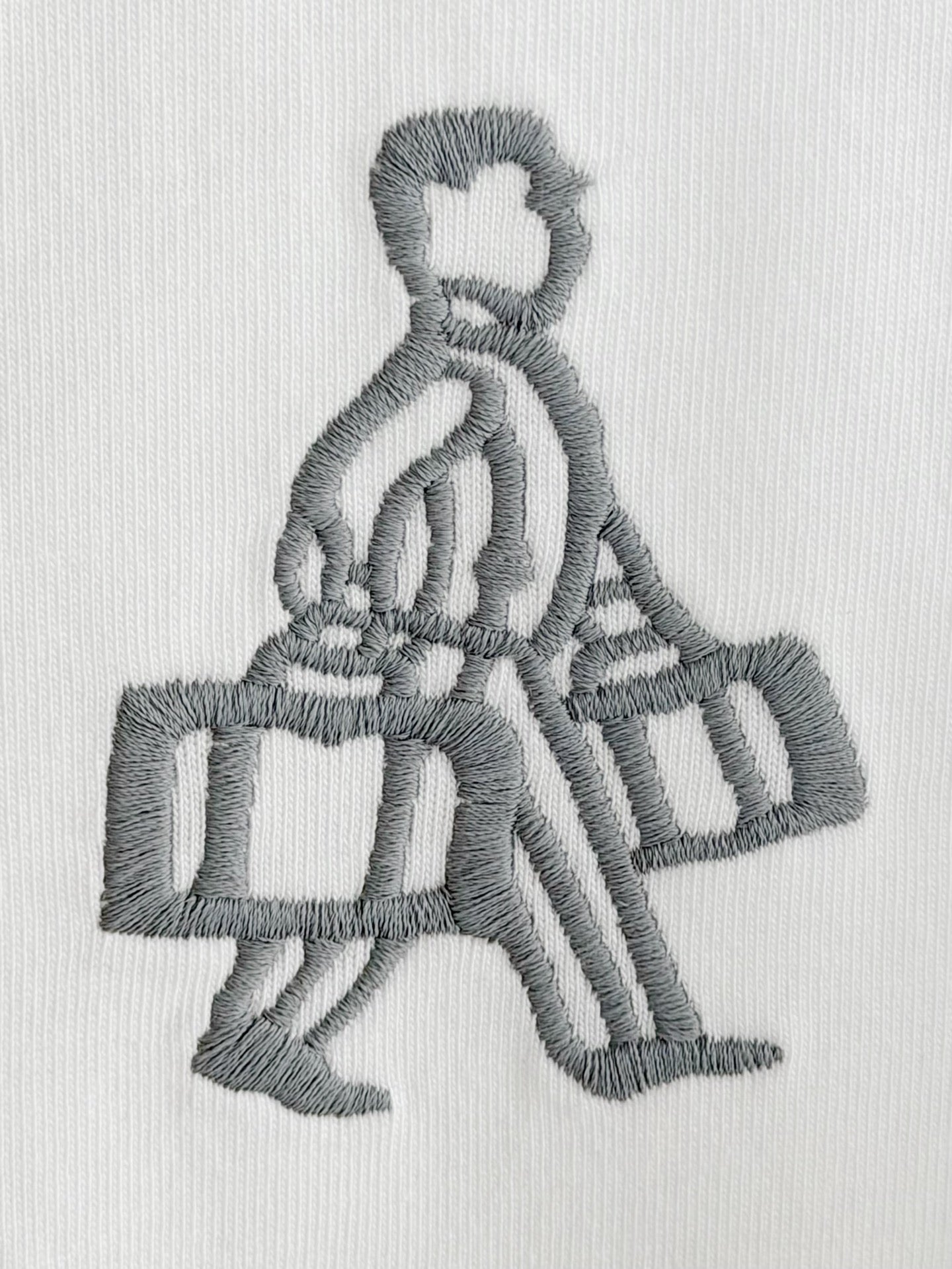 Embroidered gray figure holding a box on white Prada T-shirt