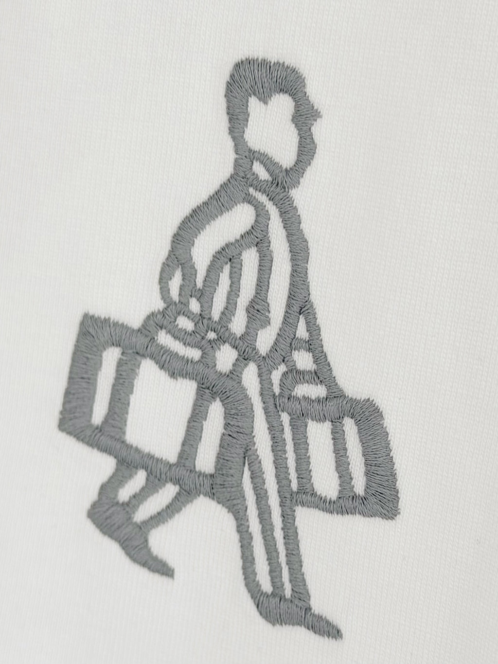 Embroidered gray figure holding a bag on white Prada T-shirt