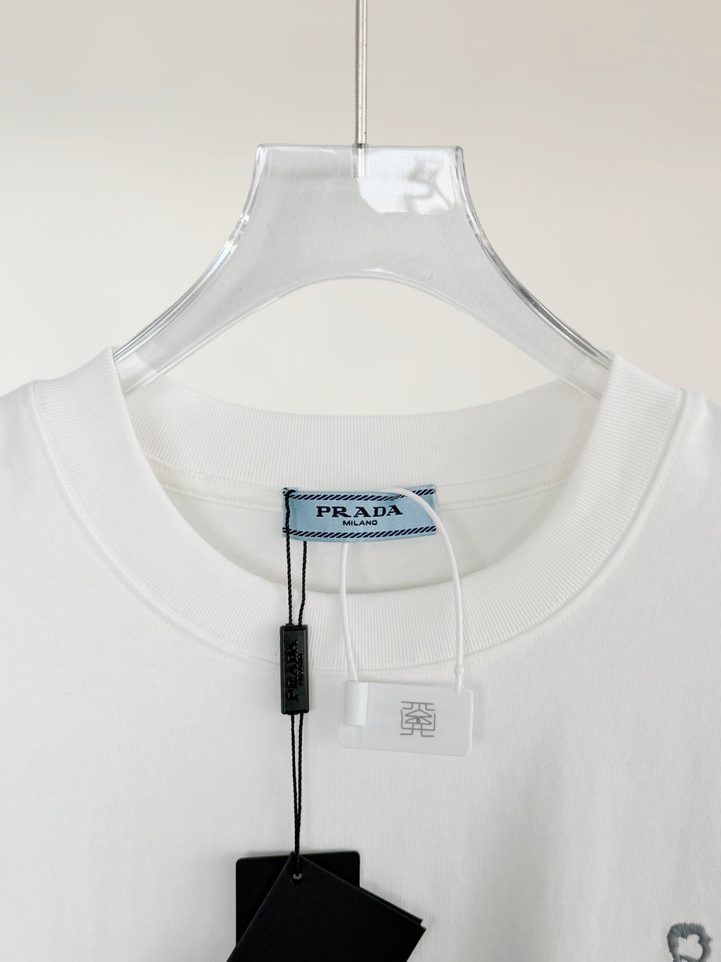 White Prada T-shirt neckline with brand tag and size label
