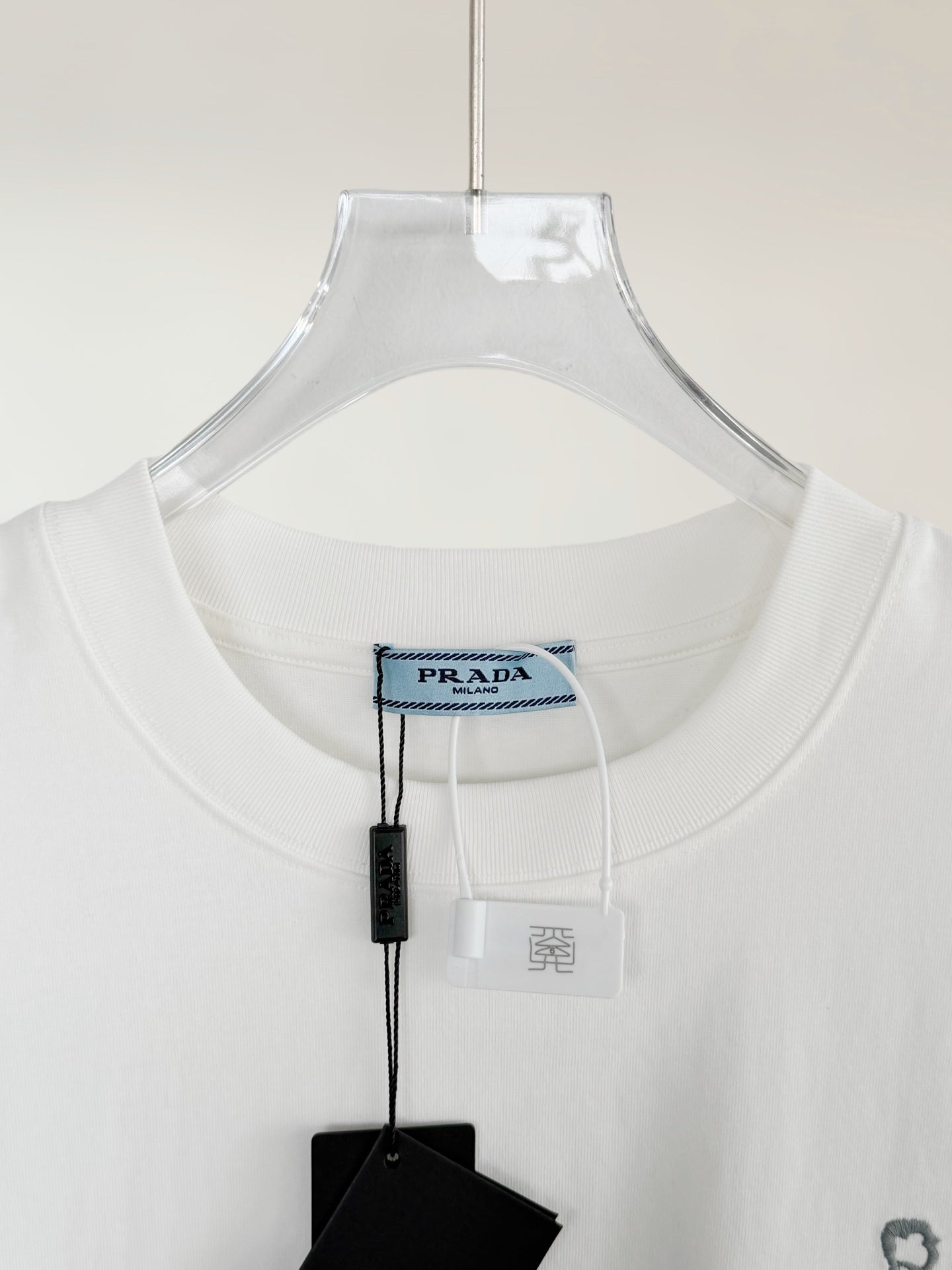 White Prada T-shirt neckline with brand tag and size label
