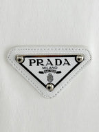 Prada Milano logo patch on white fabric with silver studs