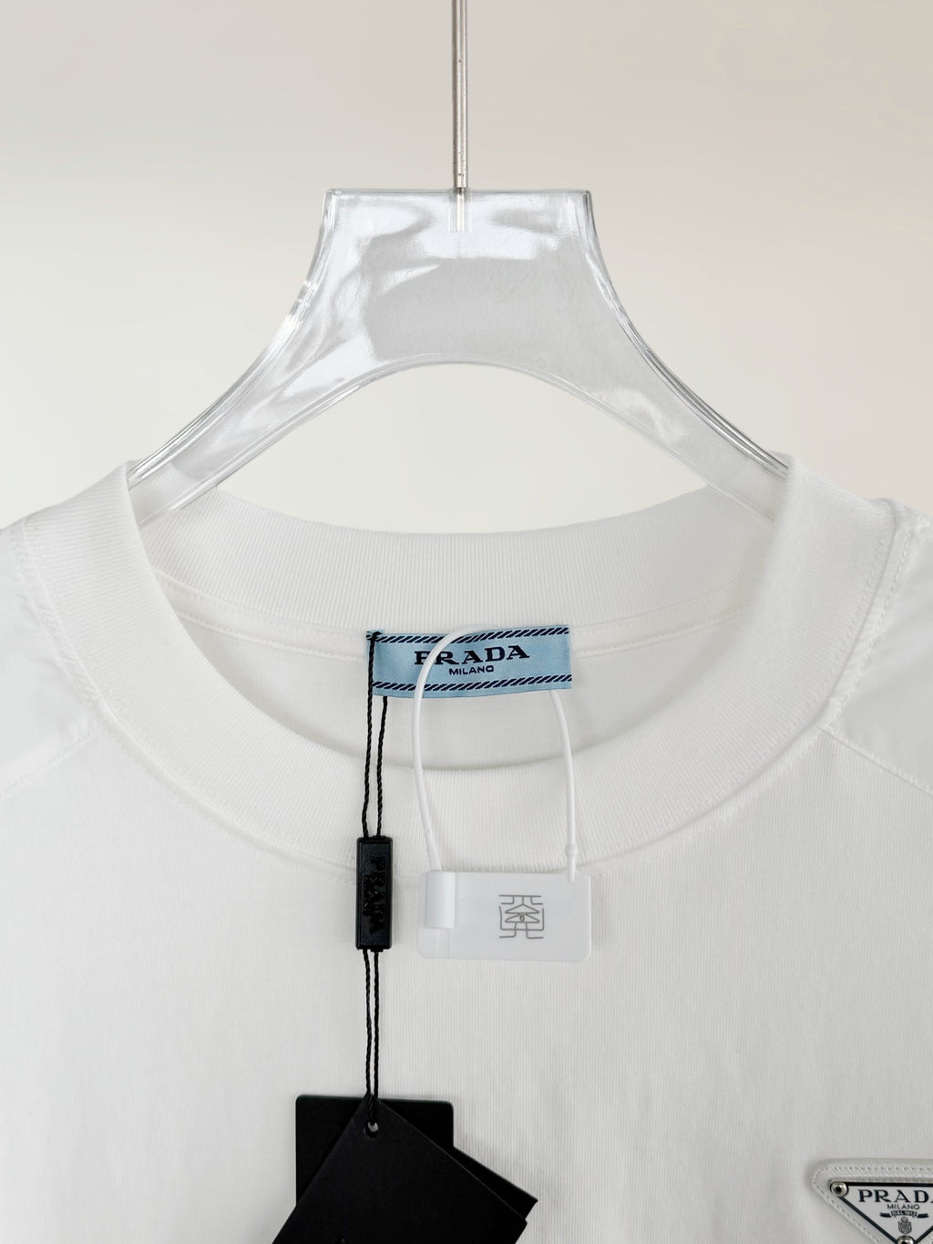 White T-shirt collar with Prada logo tag and inner neck label