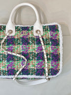 Chanel tweed handbag side view, white leather bottom, multicolor sparkly weave, chain strap