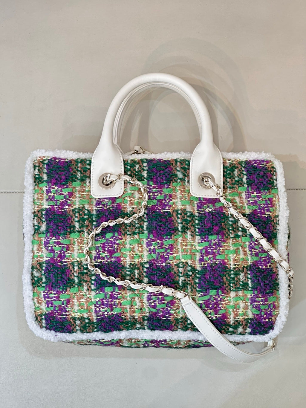Chanel tweed handbag front view, white handles, multicolor sparkly fabric, chain strap