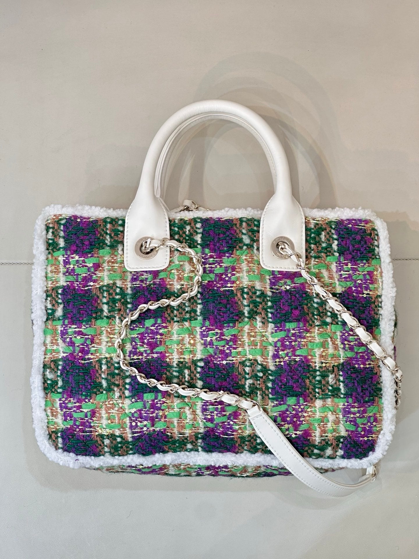 Chanel tweed handbag front view, white handles, multicolor sparkly fabric, chain strap