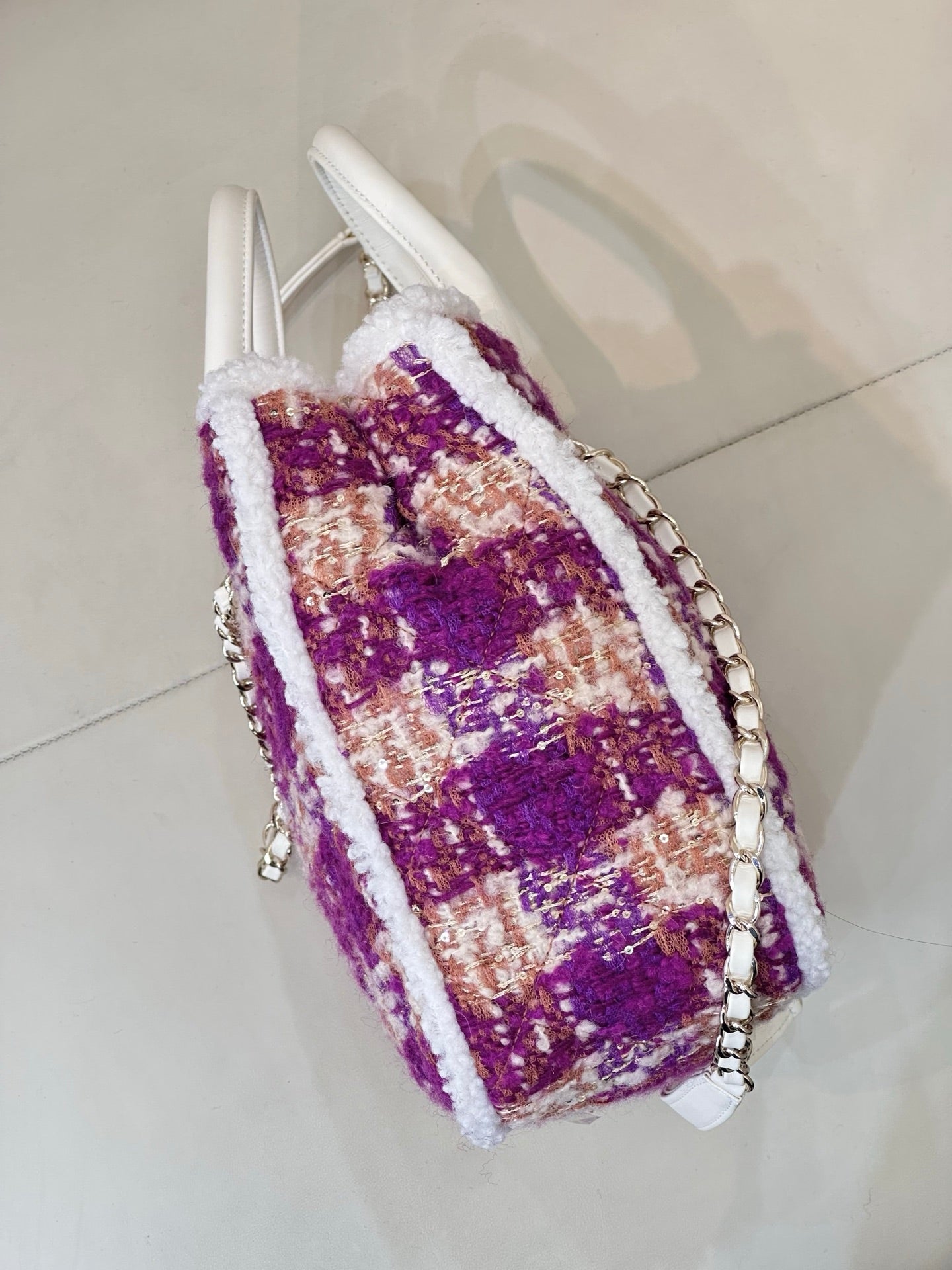 Chanel bag side view in purple and cream tweed with silver chain strap