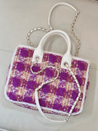 Chanel bag angled view with purple plaid tweed, white handles, and silver chain