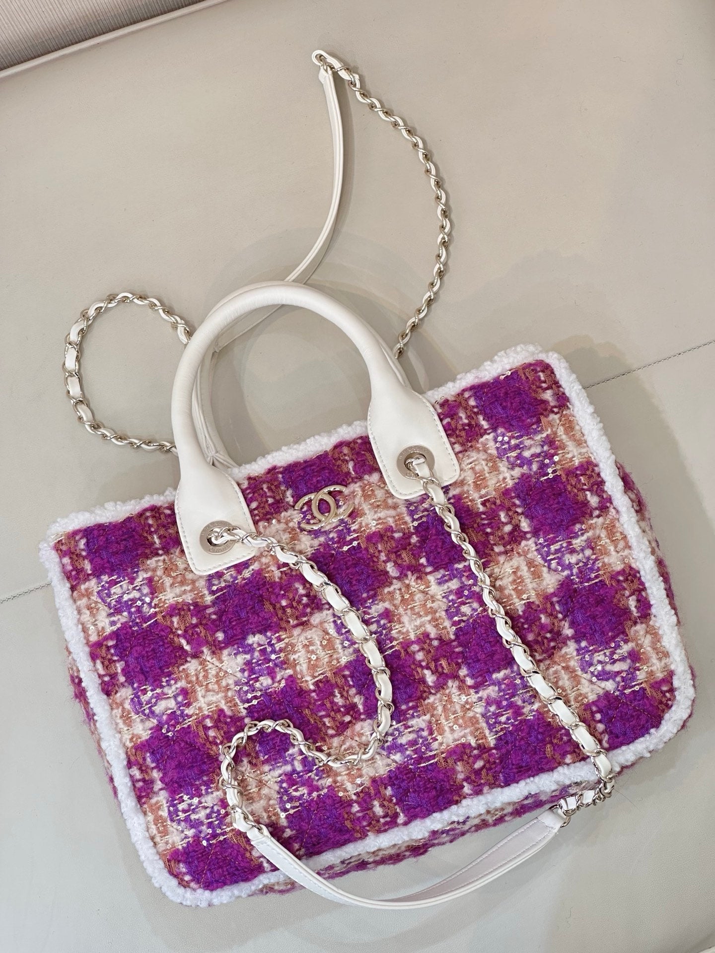 Chanel bag with purple plaid tweed, white handles, and silver chain shoulder strap