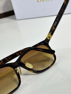 Dior sunglasses close-up of tortoise temple and tan tinted lens