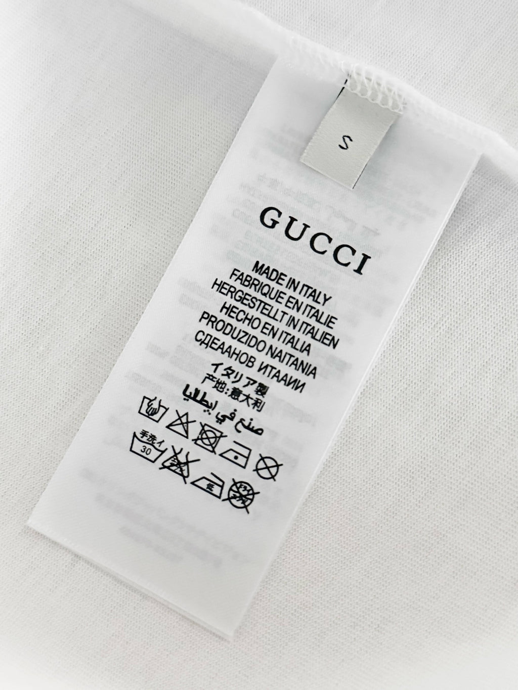 White T-shirt care label with size and Made in Italy information