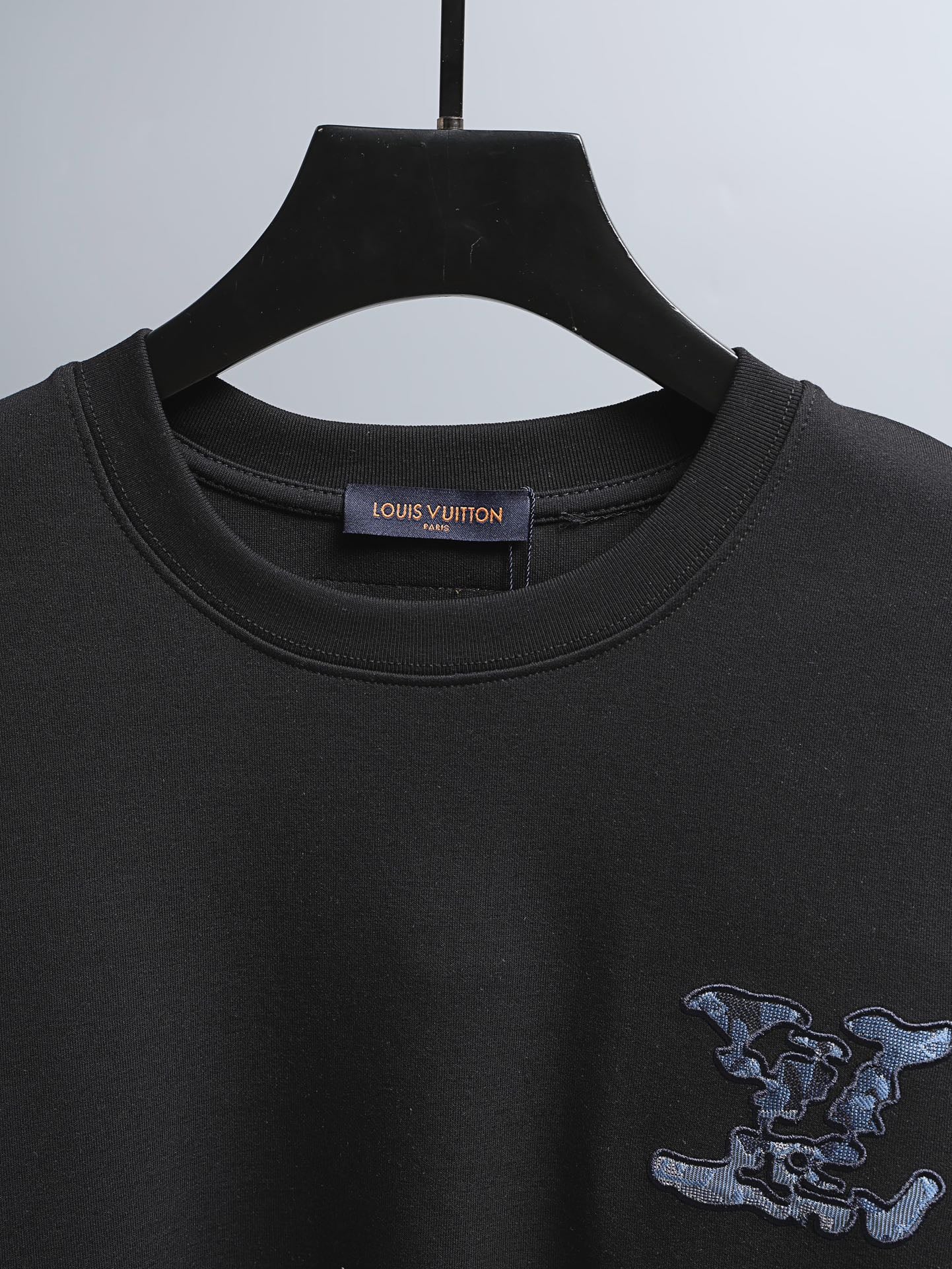 Black crewneck short-sleeve T-shirt with inner neckline logo tag and graphic