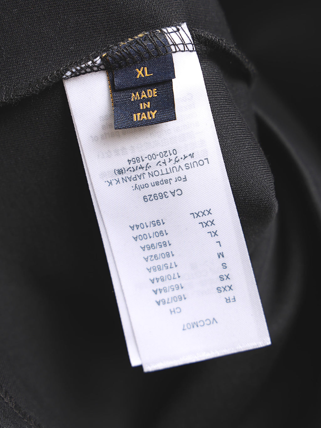 Black T-shirt size label showing XL and "Made in Italy"