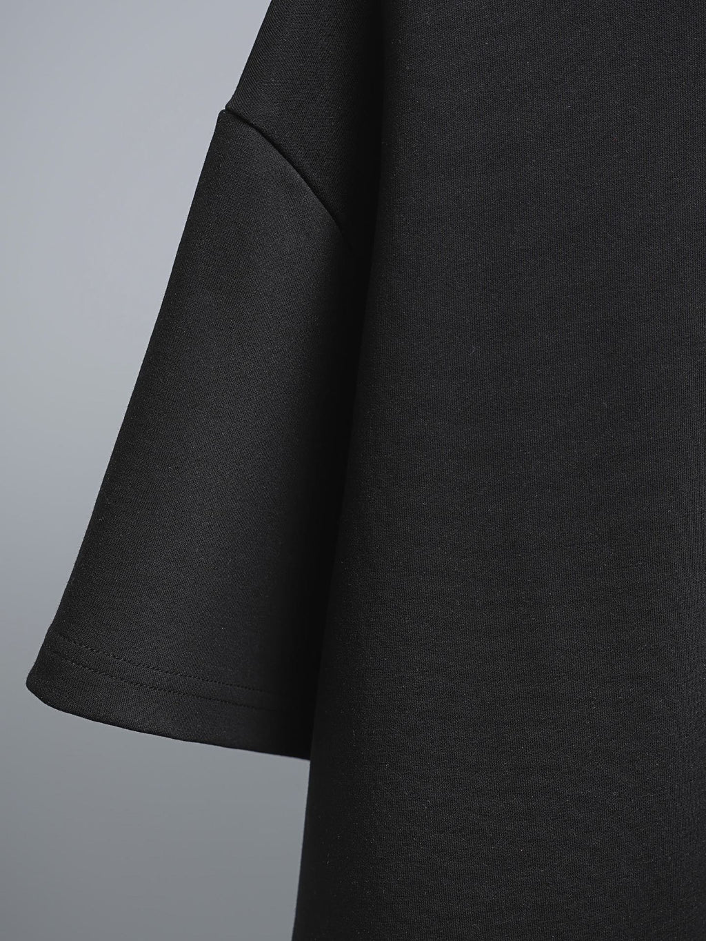 Black short-sleeve T-shirt side view with curved hemline