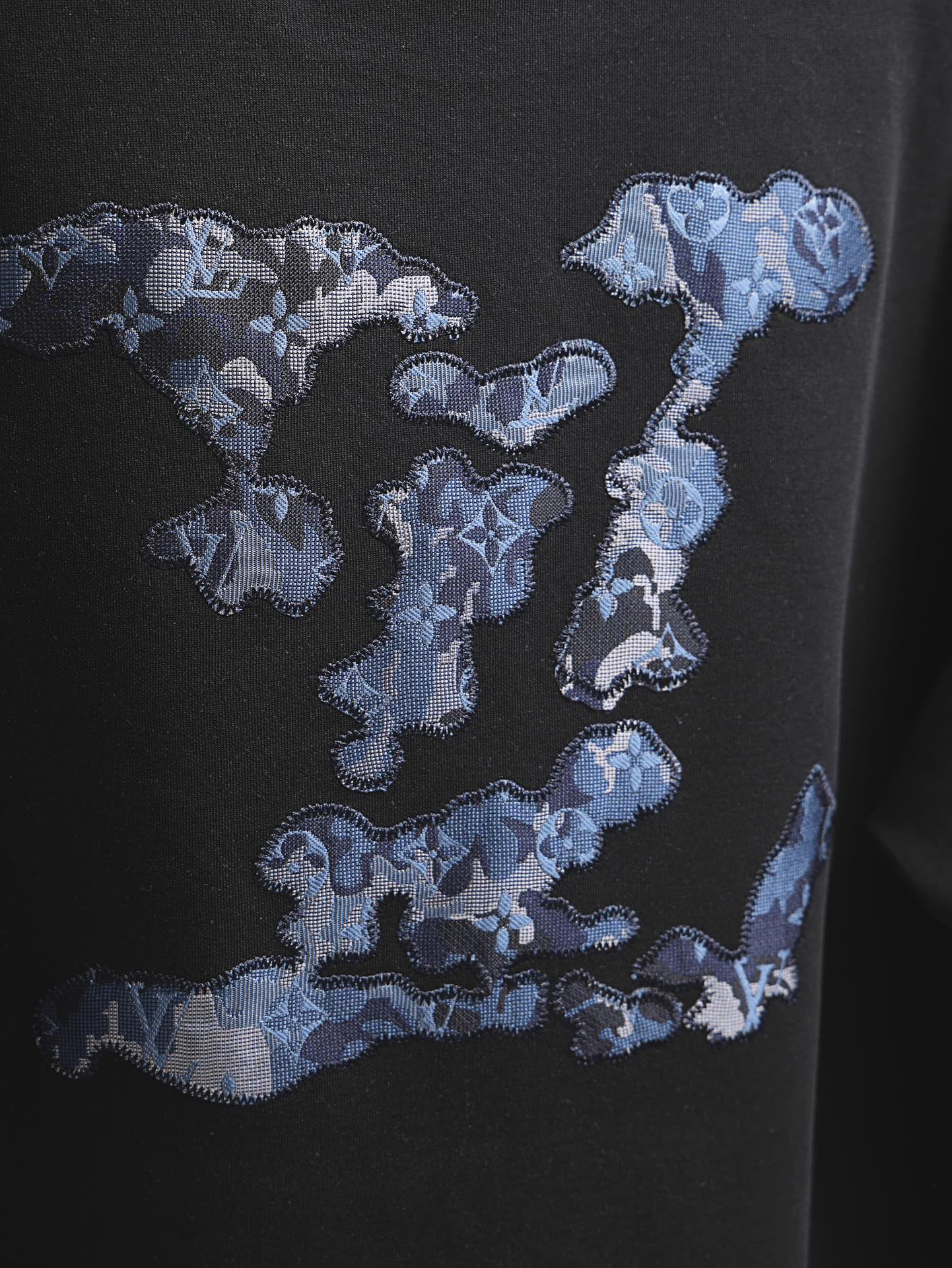 Black short-sleeve T-shirt with large blue graphic print on chest
