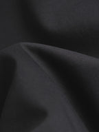 Black T-shirt fabric close-up with fine textured weave