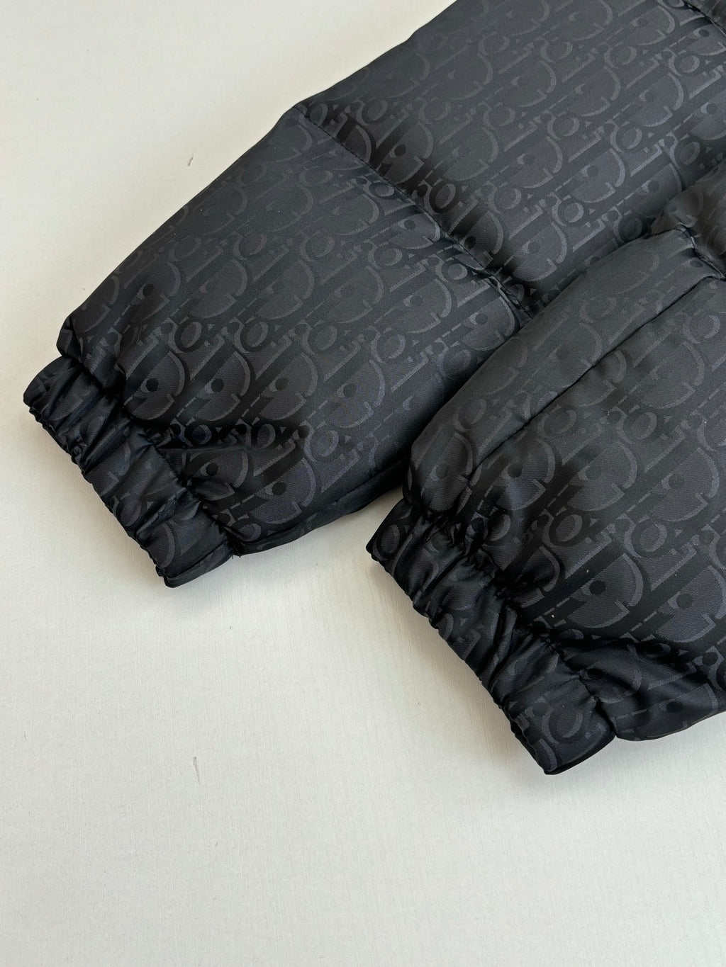 Long quilted puffer jacket in dark gray with Dior monogram pattern and gathered cuffs