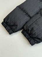 Long quilted puffer jacket in dark gray with Dior monogram pattern and gathered cuffs