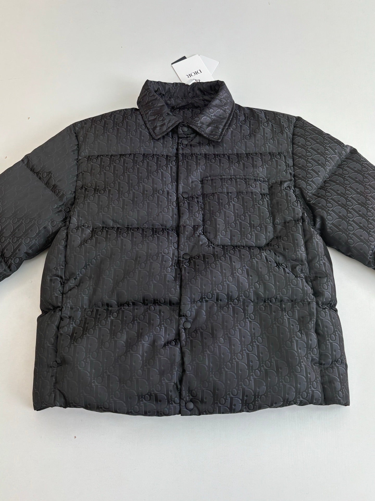 Dior long puffer jacket, dark navy, front view with chest pocket and stand collar