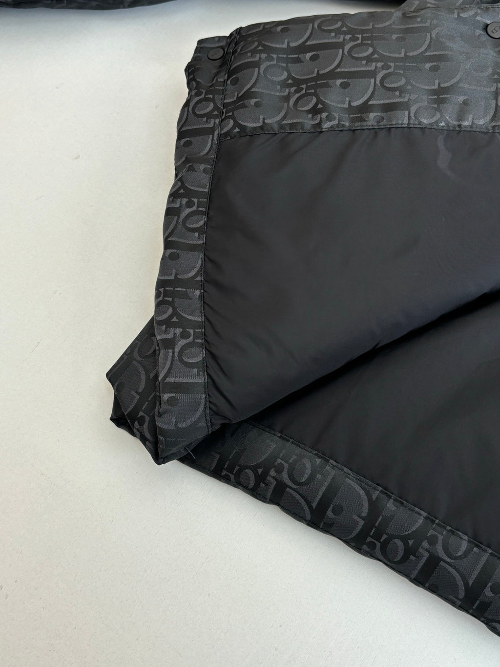 Dior long puffer jacket, dark navy, lower back panel close-up with quilting and monogram