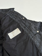 Dior long puffer jacket, dark navy, side close-up with gold snap buttons