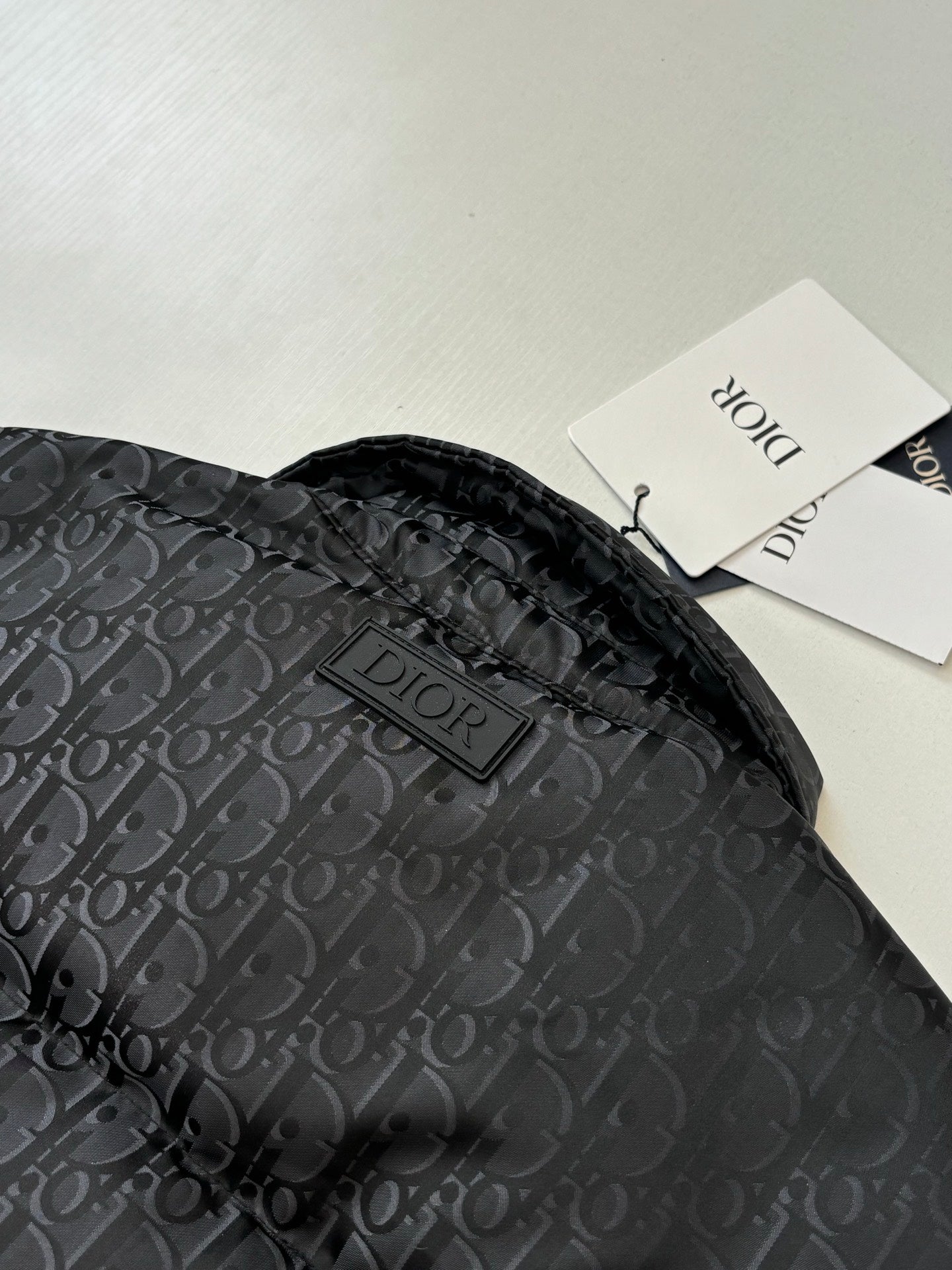 Dior long puffer jacket, dark navy, hood and Dior logo patch on monogram fabric