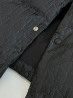 Dior long puffer jacket, dark navy, close-up of snap placket and monogram fabric