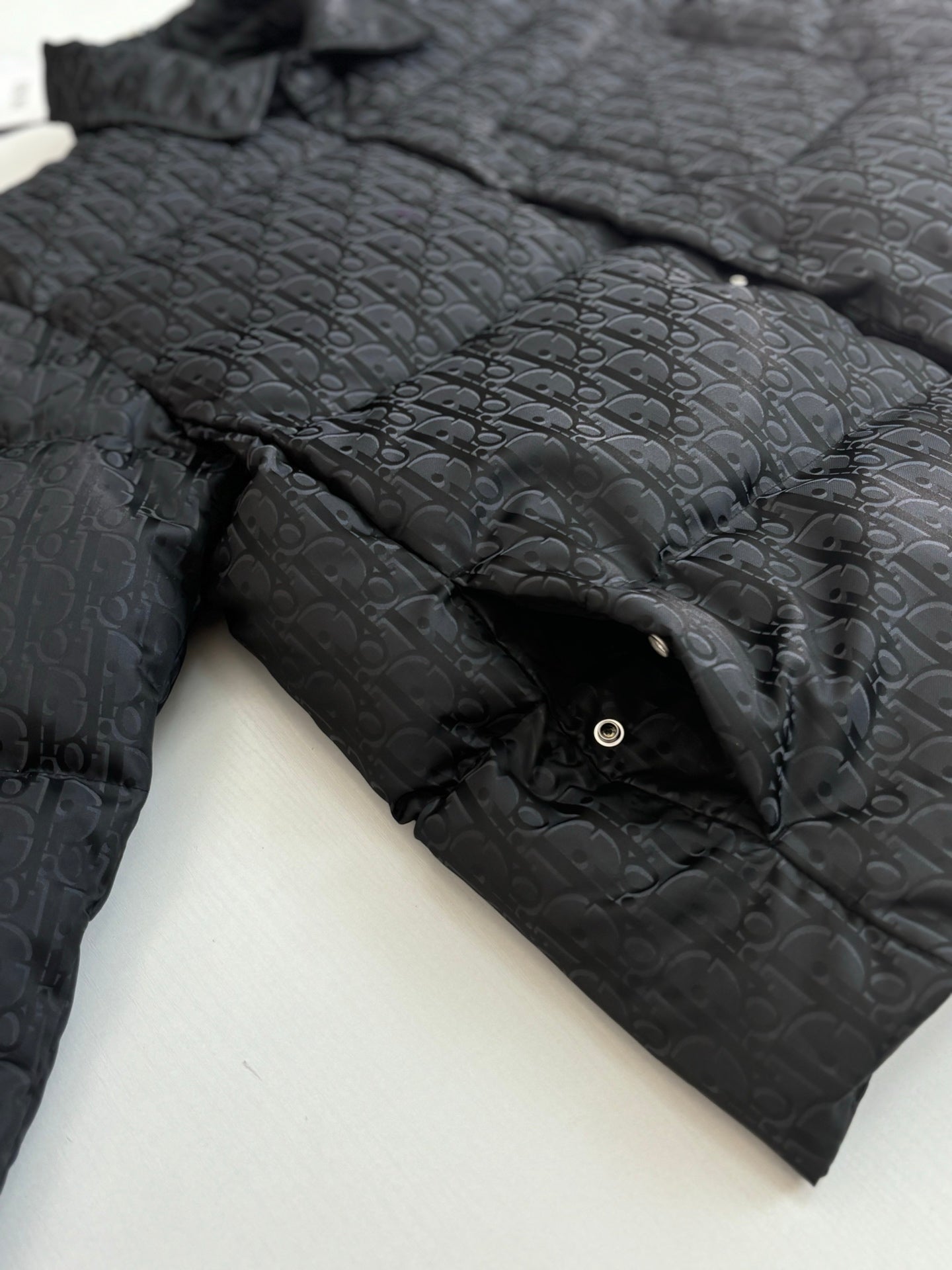 Dior long puffer jacket, dark navy, shoulder and sleeve close-up with stand collar