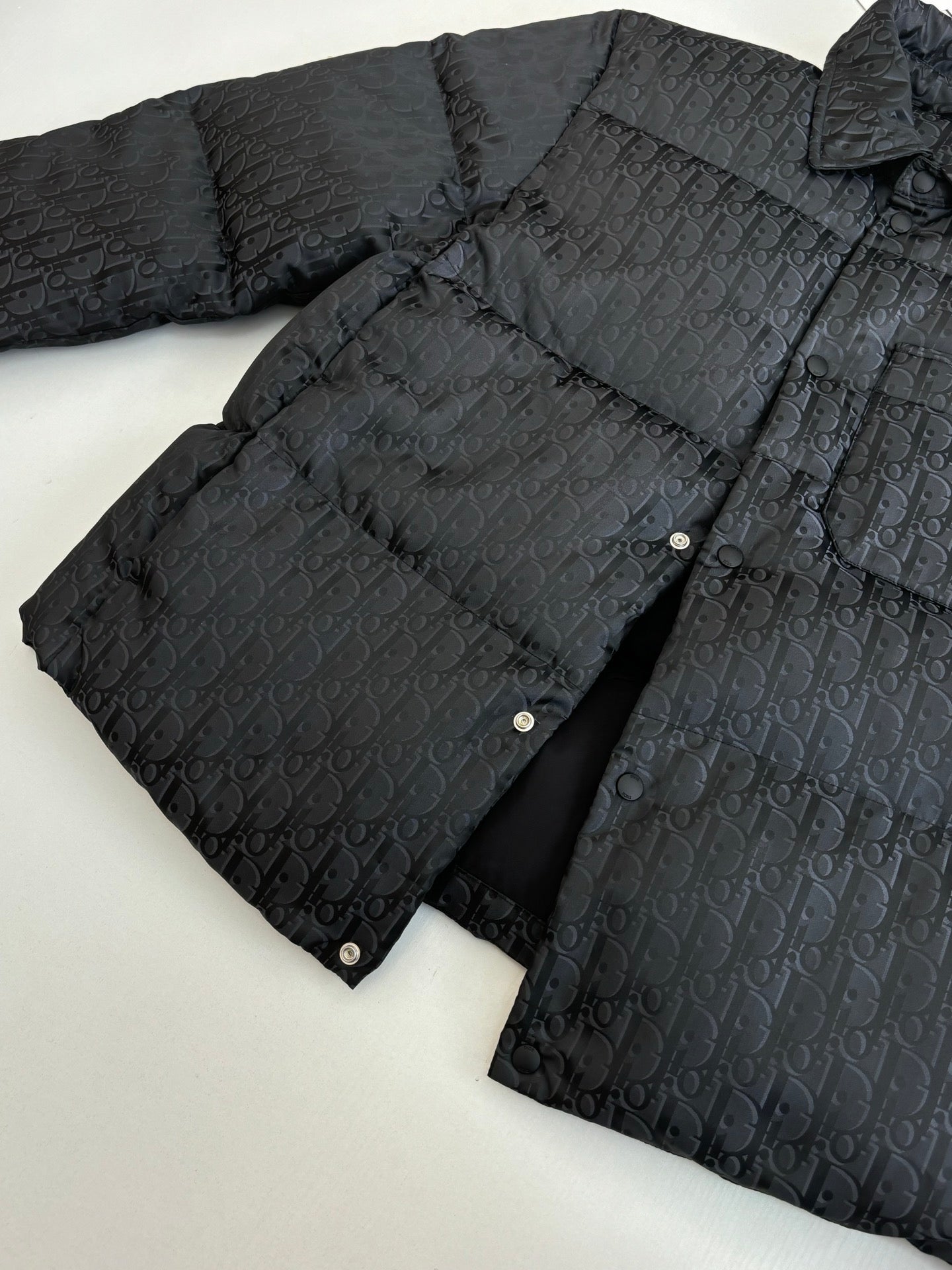 Dior long puffer jacket, dark navy, lay-flat view with buttons and stand collar