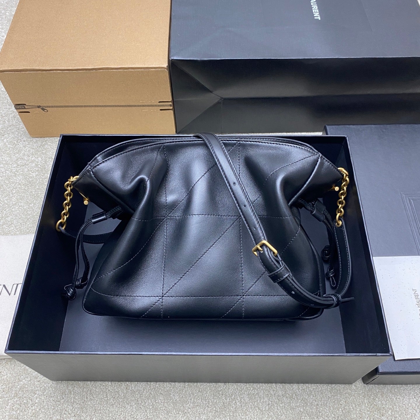 Black YSL quilted leather shoulder bag with gold hardware and chain strap