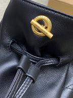 Black YSL leather bag close-up with gold “SAINT LAURENT PARIS” logo