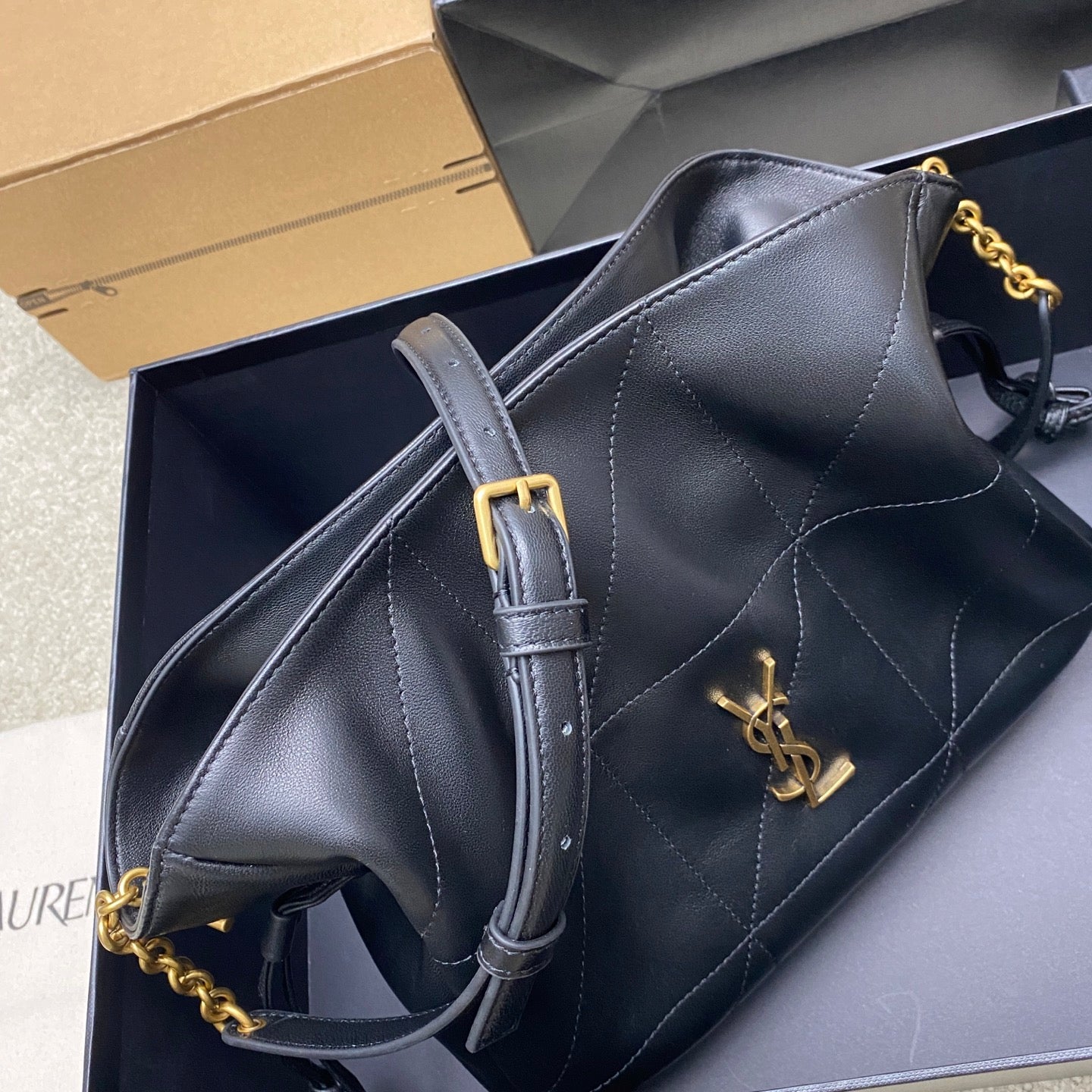 Black YSL leather bag with front gold logo and chain-and-leather strap