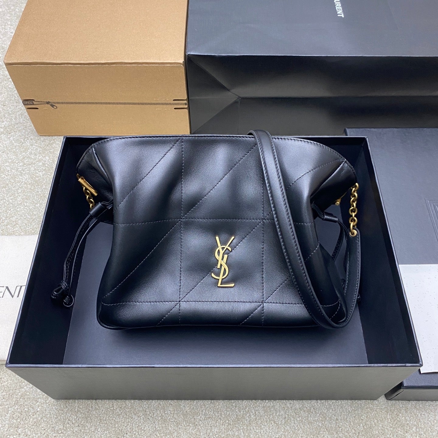 Black YSL quilted leather bag with gold logo and chain shoulder strap