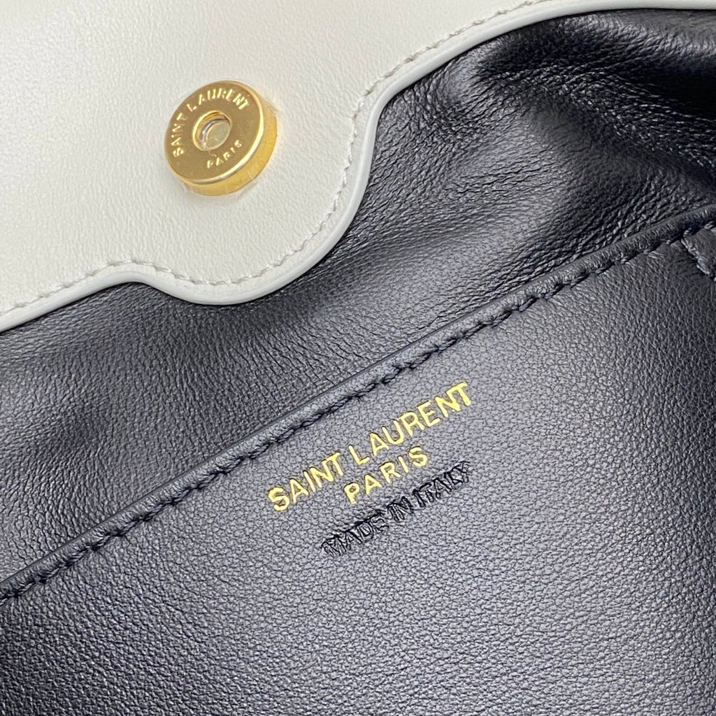 YSL bag close-up: gold Saint Laurent Paris text on dark interior label