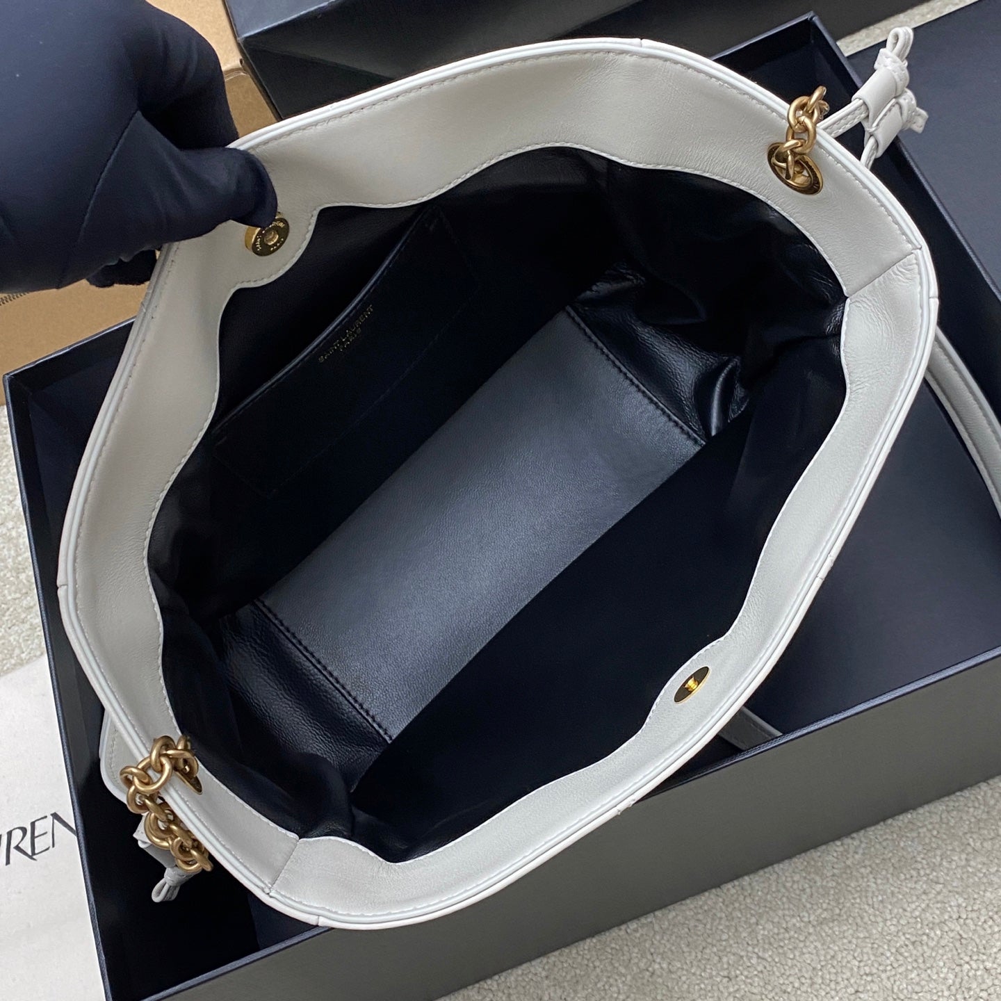 YSL bag open top showing dark lined interior and interior pocket