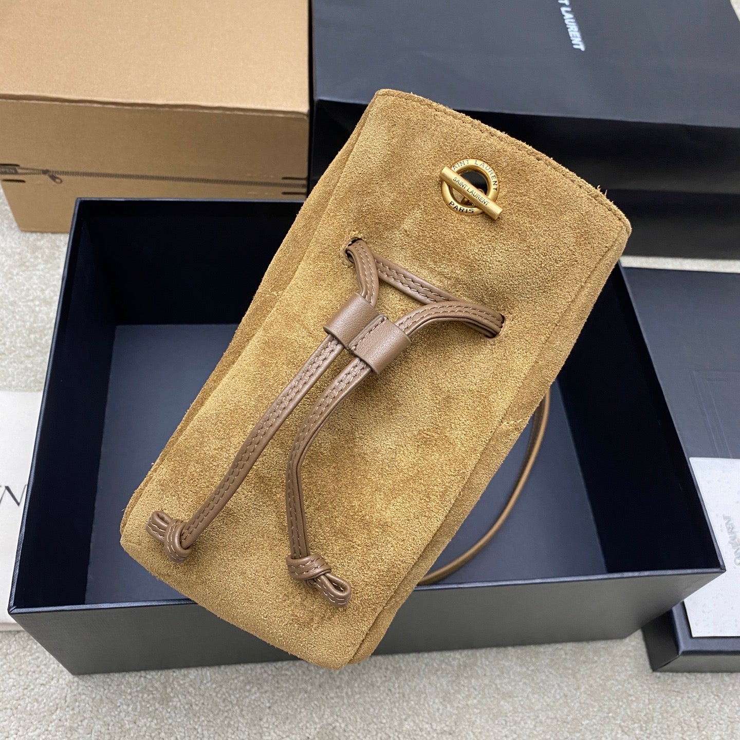 YSL suede small pouch bag with drawcord tassels and top flap, gold YSL emblem
