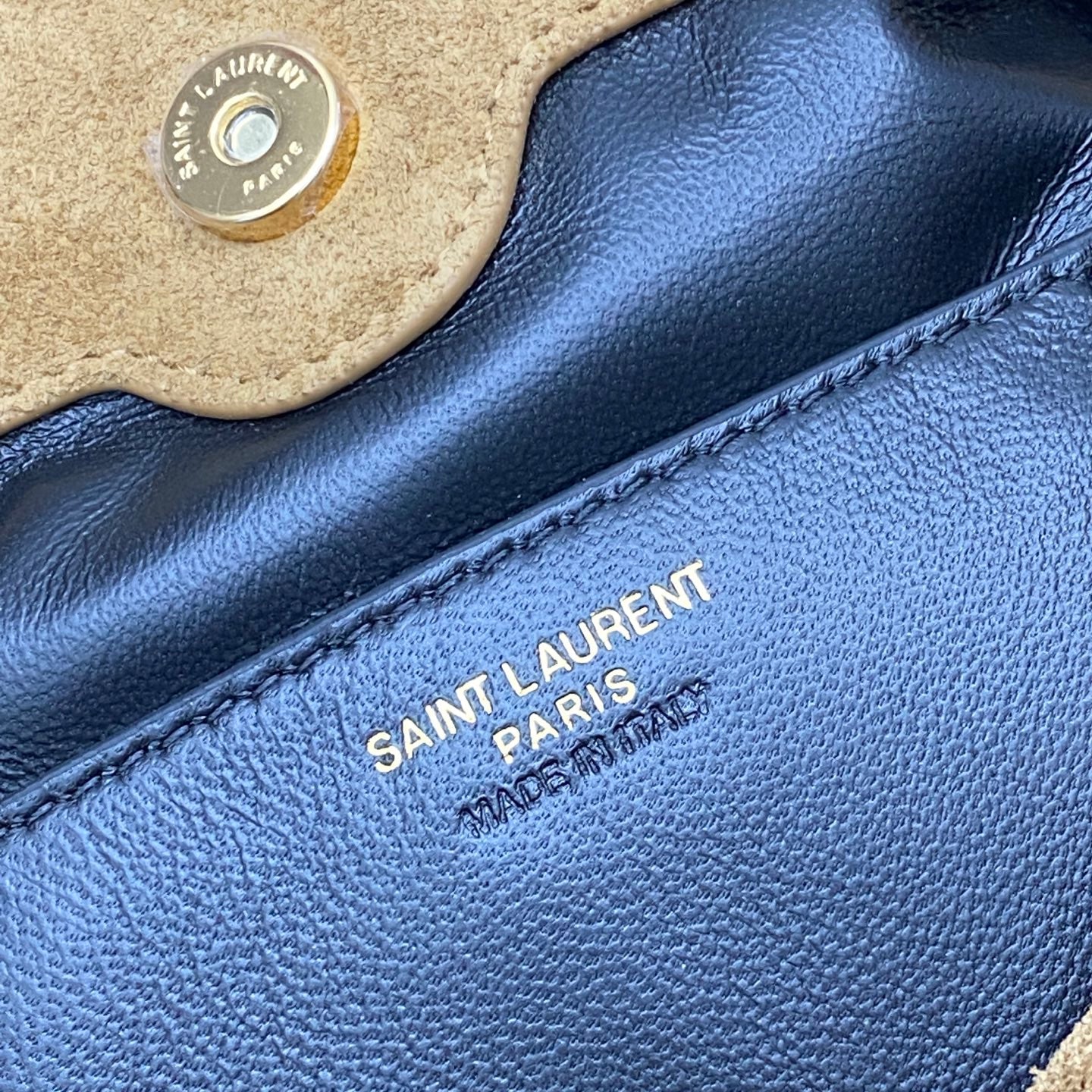 YSL 'SAINT LAURENT PARIS' stamp on blue leather lining with stitching