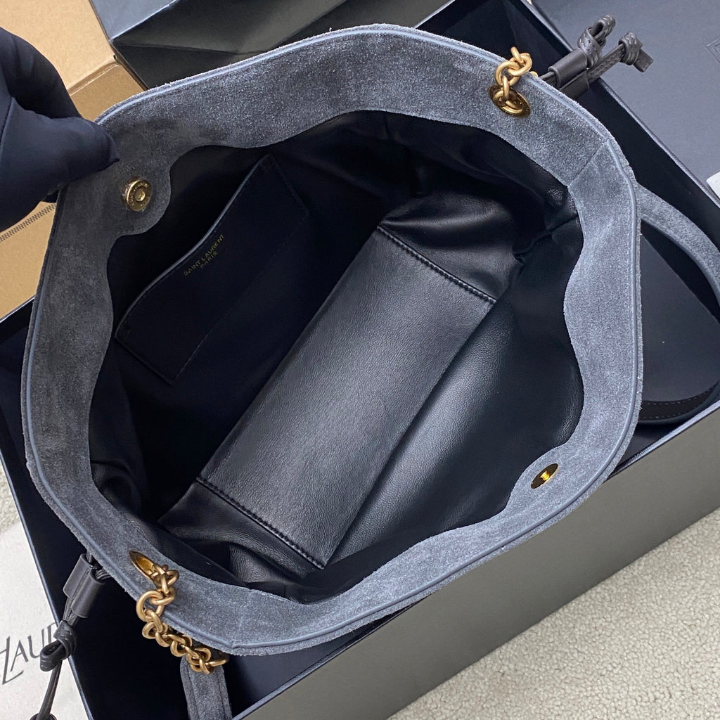Blue-gray suede YSL bag open to reveal black leather interior and pocket